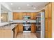 Well-lit kitchen featuring stainless steel appliances, wooden cabinets, and neutral countertops at 25087 W Dove Gap Dr, Buckeye, AZ 85326