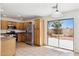 Well-lit kitchen and dining area featuring stainless steel appliances and sliding door to outdoor patio at 25087 W Dove Gap Dr, Buckeye, AZ 85326