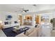 Bright living room boasts white sofas, a modern coffee table, and an open floor plan to the kitchen at 25087 W Dove Gap Dr, Buckeye, AZ 85326