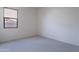 Simple bedroom with neutral carpeting and a large window at 257 S 165Th Ave, Goodyear, AZ 85338
