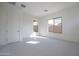 Comfortable bedroom offering neutral carpeting and multiple windows for natural light and backyard views at 257 S 165Th Ave, Goodyear, AZ 85338