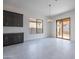 Bright dining area showcasing stylish chandelier, dark cabinets, and sliding glass doors to backyard at 257 S 165Th Ave, Goodyear, AZ 85338