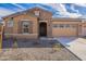 Charming single-Gathering home with a well-manicured front yard, stone accents, and inviting curb appeal at 257 S 165Th Ave, Goodyear, AZ 85338