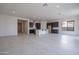 Bright and airy living room features tile flooring, open layout, and seamless flow to the kitchen at 257 S 165Th Ave, Goodyear, AZ 85338