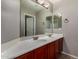 Bathroom with double sinks, wood cabinetry, and large mirror at 2718 S Cupertino Dr, Gilbert, AZ 85295