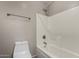 Bathroom featuring a shower-tub combination with white tile surround at 2718 S Cupertino Dr, Gilbert, AZ 85295