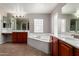 View of bathroom with garden tub and double sinks and cabinets at 2718 S Cupertino Dr, Gilbert, AZ 85295