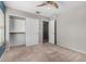 Neutral bedroom featuring carpet, ceiling fan, a closet, and doors to the ensuite at 2718 S Cupertino Dr, Gilbert, AZ 85295