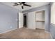 Bedroom featuring a ceiling fan, carpet, closet, and view to the ensuite at 2718 S Cupertino Dr, Gilbert, AZ 85295