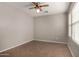 Bedroom with wood-look tile, neutral paint, and fan and light fixture at 2718 S Cupertino Dr, Gilbert, AZ 85295