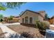 A side view of a charming home featuring stone veneer and well-maintained landscaping at 2718 S Cupertino Dr, Gilbert, AZ 85295