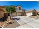 Charming two-story home featuring a three-car garage and beautiful stone accents at 2718 S Cupertino Dr, Gilbert, AZ 85295