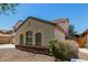 A side view of a charming home featuring stone veneer and well-maintained landscaping at 2718 S Cupertino Dr, Gilbert, AZ 85295