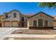 Charming two-story home featuring a three-car garage and beautiful stone accents at 2718 S Cupertino Dr, Gilbert, AZ 85295