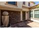 Inviting covered front porch with stone accents, a decorative sphere and contemporary style front door at 2718 S Cupertino Dr, Gilbert, AZ 85295