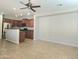 Open-concept living area flowing into a kitchen with stainless steel appliances and a breakfast bar at 2718 S Cupertino Dr, Gilbert, AZ 85295