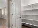 Corner pantry with multiple shelves for storing dry goods and appliances at 2718 S Cupertino Dr, Gilbert, AZ 85295