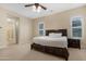 Spacious bedroom with carpet, ceiling fan, and large windows allowing for plenty of natural light at 2856 E Desert Broom Pl, Chandler, AZ 85286