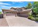 Charming two-story home with a three-car garage and beautiful desert landscaping in the front yard at 2856 E Desert Broom Pl, Chandler, AZ 85286