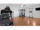 Spacious gym with various equipment, ceiling fan, and wood-look floors at 2856 E Desert Broom Pl, Chandler, AZ 85286