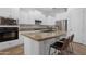 Bright kitchen features stainless appliances, granite countertops, white cabinetry, and an island with bar seating at 2856 E Desert Broom Pl, Chandler, AZ 85286