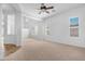 Bright living room with carpeted flooring, white walls, and large windows providing natural light at 2856 E Desert Broom Pl, Chandler, AZ 85286