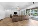 Bright and airy living room with modern furnishings, a ceiling fan, and sliding doors to the pool area at 2856 E Desert Broom Pl, Chandler, AZ 85286