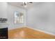 Office space with wood flooring and a large window, providing natural light, ideal for a home office at 2856 E Desert Broom Pl, Chandler, AZ 85286