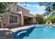 Inviting backyard with a sparkling pool, flowering plants, and an outdoor seating area at 2856 E Desert Broom Pl, Chandler, AZ 85286