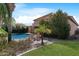 Serene backyard with a sparkling pool, desert plants, and comfortable lounge chairs at 2856 E Desert Broom Pl, Chandler, AZ 85286