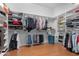 Spacious walk-in closet with built-in shelving and hanging rods, providing ample storage space at 2856 E Desert Broom Pl, Chandler, AZ 85286