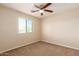 Bedroom has a ceiling fan, carpet and a bright window with blinds at 30617 N 138Th Way, Scottsdale, AZ 85262