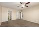 Spacious bedroom featuring neutral walls, carpet, ceiling fan, and multiple closets at 30617 N 138Th Way, Scottsdale, AZ 85262