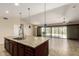 Kitchen island featuring granite countertops, double sinks, and stainless steel appliances at 30617 N 138Th Way, Scottsdale, AZ 85262