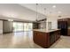 Open kitchen featuring an island with granite countertops, stainless steel appliances, and a tile floor at 30617 N 138Th Way, Scottsdale, AZ 85262