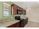 Well-lit kitchen with dark wood cabinets, granite countertops, and stainless steel appliances at 30617 N 138Th Way, Scottsdale, AZ 85262