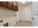 Laundry room with upper cabinets, tile flooring and garage access at 30617 N 138Th Way, Scottsdale, AZ 85262