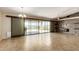 Open living room with tile floors, stone accent wall, and sliding glass doors at 30617 N 138Th Way, Scottsdale, AZ 85262