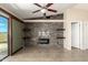 Open living room with tile floors, stone accent wall, and sliding glass doors at 30617 N 138Th Way, Scottsdale, AZ 85262
