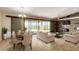 A cozy living room with a stone accent wall and sliding glass doors at 30617 N 138Th Way, Scottsdale, AZ 85262