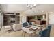 Open-concept living space with a stone fireplace and modern kitchen at 30617 N 138Th Way, Scottsdale, AZ 85262