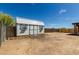 Charming storage shed with a white metal roof and blue trim nestled in a spacious yard at 30617 N 138Th Way, Scottsdale, AZ 85262