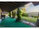 Lush backyard featuring a covered patio, manicured lawn, and mature landscaping, perfect for outdoor enjoyment at 325 E Sharon Ave, Phoenix, AZ 85022