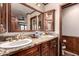 Bathroom with double sinks, granite counters, wooden cabinets at 325 E Sharon Ave, Phoenix, AZ 85022
