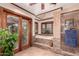 Bathroom featuring a walk-in shower, bath, window and wood accents at 325 E Sharon Ave, Phoenix, AZ 85022