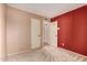 A large open bedroom with neutral and red walls at 325 E Sharon Ave, Phoenix, AZ 85022