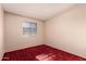 Bedroom featuring a bright red carpet and a window at 325 E Sharon Ave, Phoenix, AZ 85022
