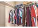 A large walk-in closet full of colorful hanging clothes at 325 E Sharon Ave, Phoenix, AZ 85022