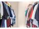 A large walk-in closet full of colorful hanging clothes at 325 E Sharon Ave, Phoenix, AZ 85022