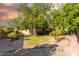 The front yard features lush trees and desert landscaping at 325 E Sharon Ave, Phoenix, AZ 85022